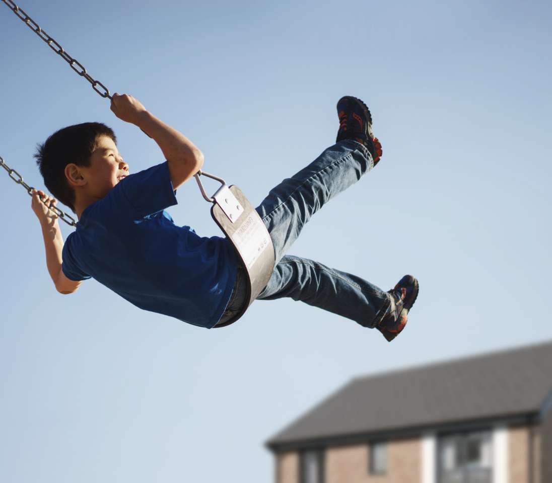 a child playing on a swing